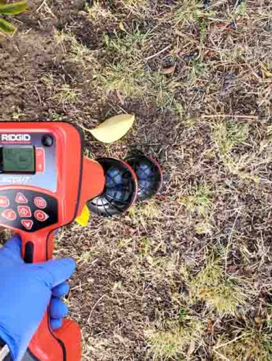 Advanced leak detection equipment being used outdoors, highlighting the use of technology in modern plumbing diagnostics.